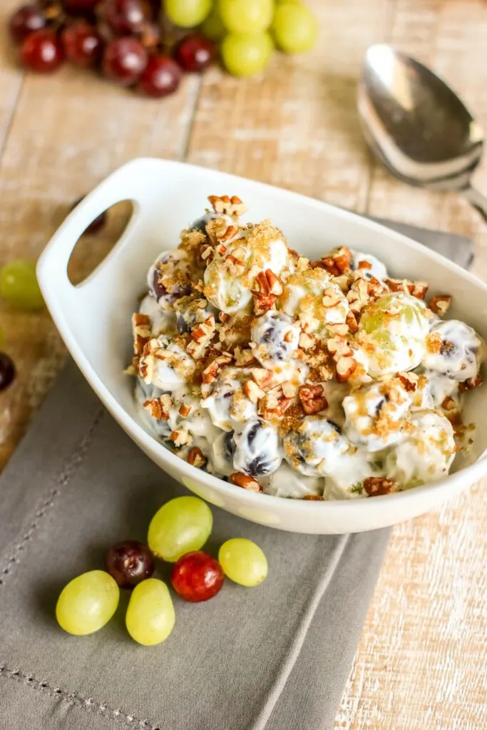 easy creamy grape salad served in a dish gray napkin grapes on side