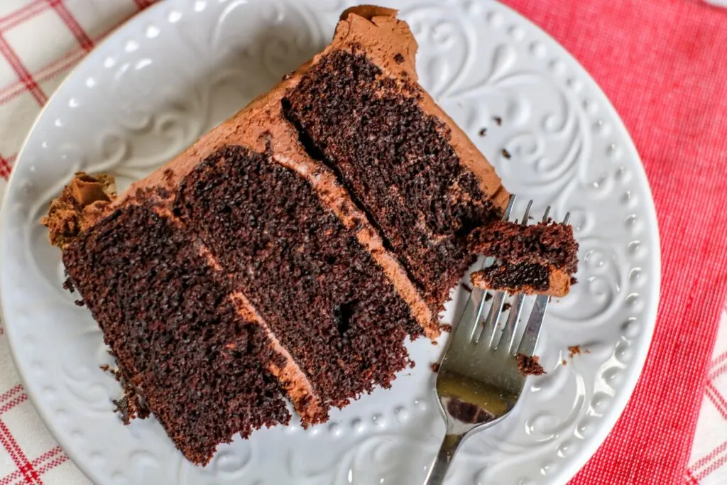 horizontal slice of cake and fork Chocolate cake with Chocolate buttercream frosting