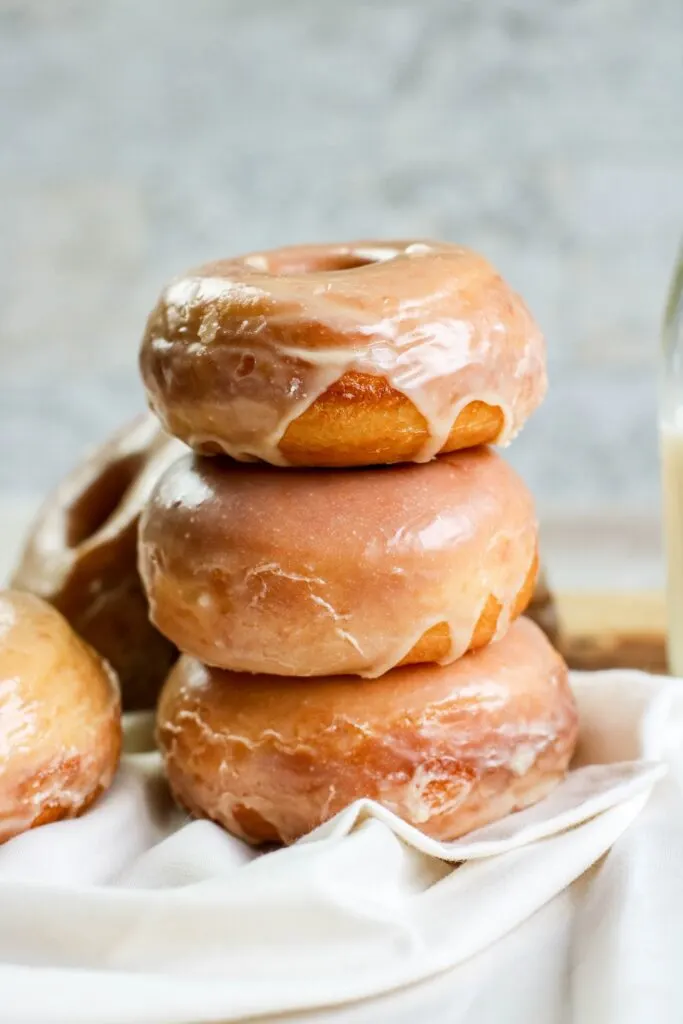 Homemade yeast doughnuts with a vanilla glaze hero stacked doughnuts vertical white napkin