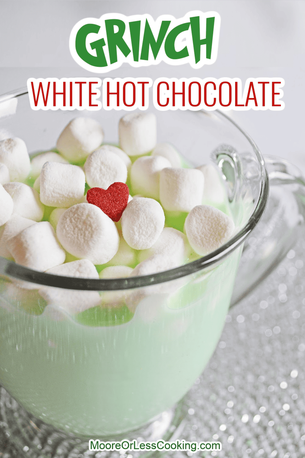 Creamy and delicious, this Grinch White Hot Chocolate recipe is a festive way to kick off the season. Cradle a cup of this warm and cozy green beverage while you watch your favorite Christmas movies. via @Mooreorlesscook
