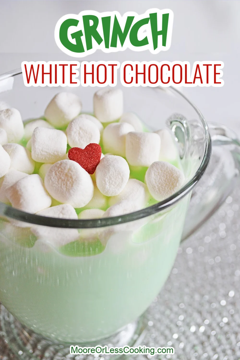 Creamy and delicious, this Grinch White Hot Chocolate recipe is a festive way to kick off the season. Cradle a cup of this warm and cozy green beverage while you watch your favorite Christmas movies. via @Mooreorlesscook