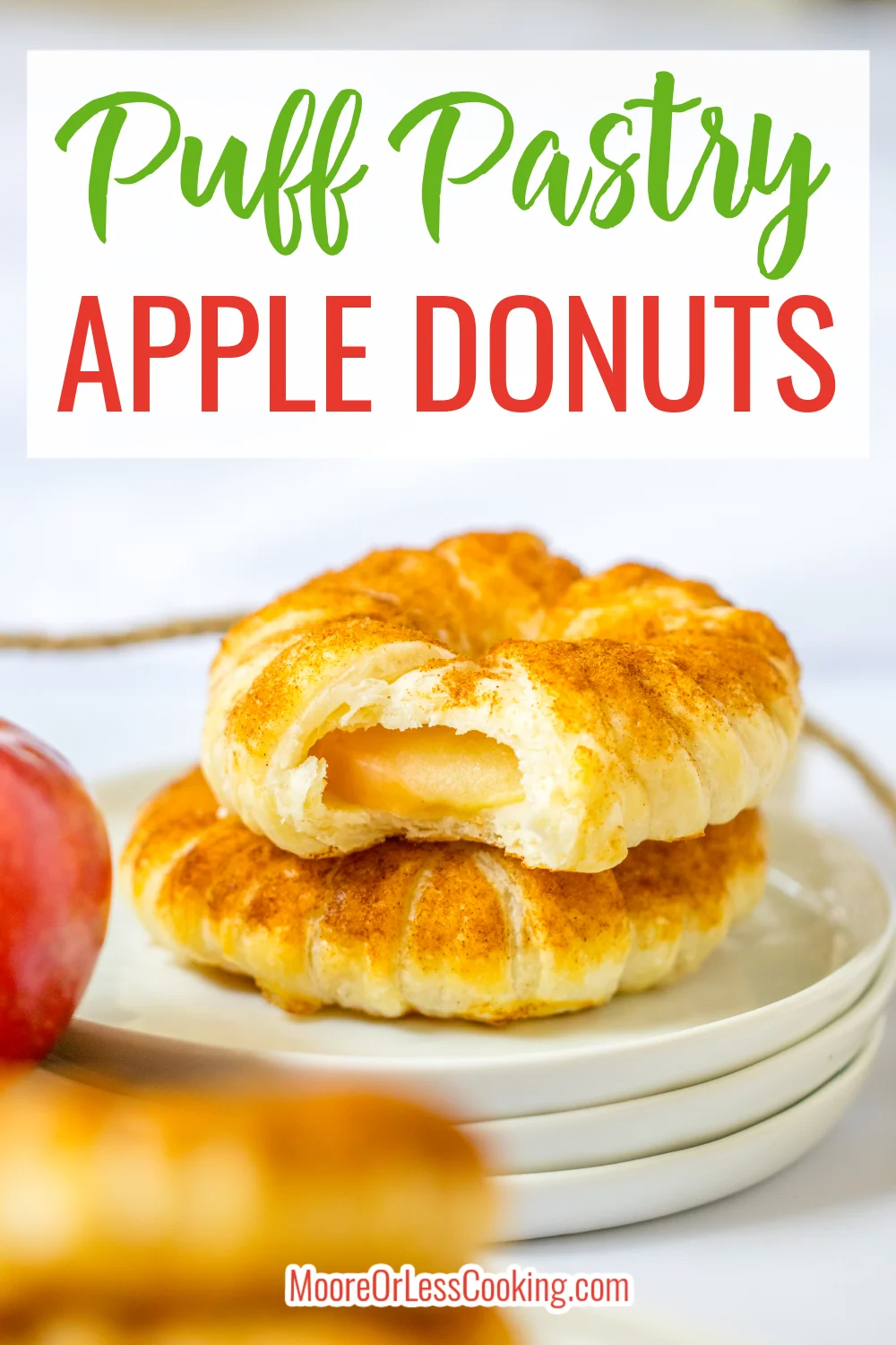 Sliced apple rings wrapped in a flaky crust and dusted with sweet and fragrant cinnamon sugar make these Puff Pastry Apple Donuts the perfect cozy fall treat. Quick and easy to assemble, these baked donuts taste just like apple pie! via @Mooreorlesscook