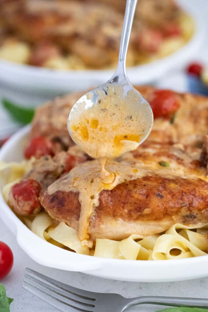 spoon gravy over chicken and pasta