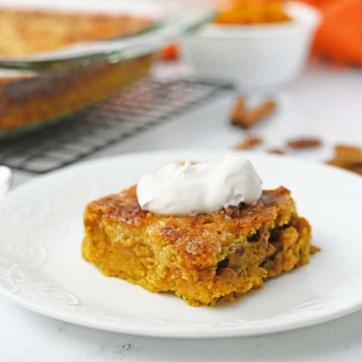 serving pumpkin dump cake with whipped cream