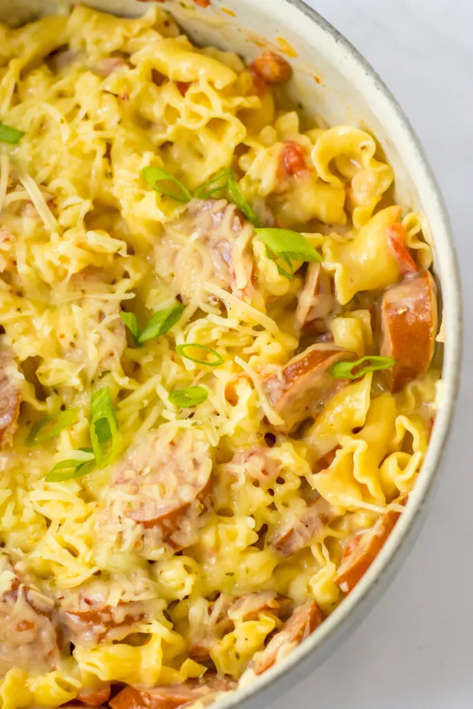 in a white pot One Pot Cheesy Sausage Pasta
