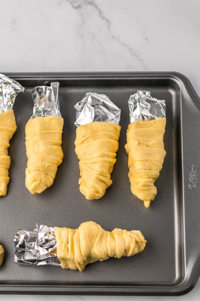 Chicken Salad Stuffed Crescents making the crescent molds