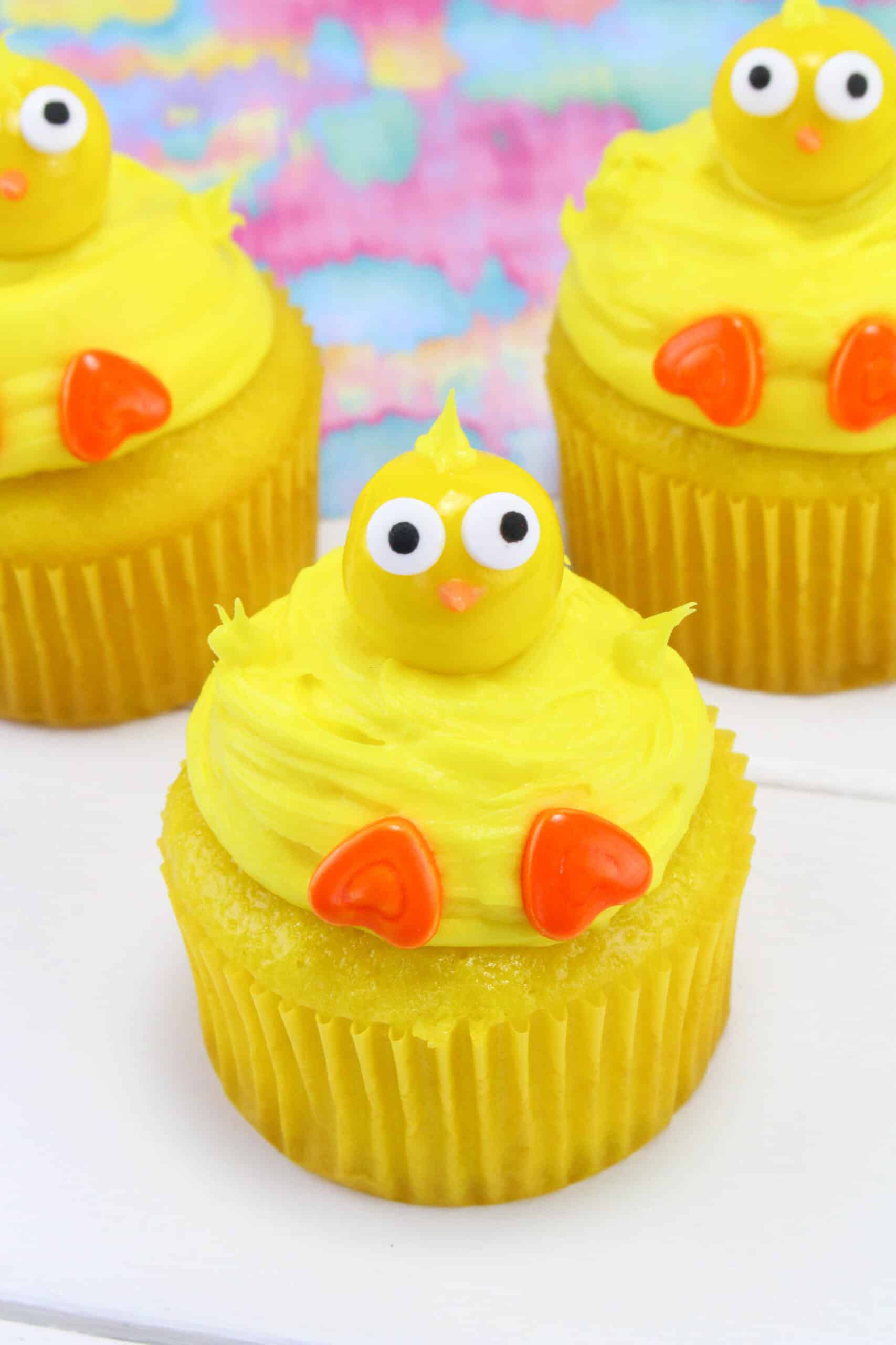 You'll love how easy it is to make these delicious Chick Cupcakes. Get started with a boxed cake mix for the cupcakes. Once baked and cooled, top the cupcakes with yellow frosting. Getting creative with candy pieces will help you form the chick. Use gumballs for the head and decorate the face with candy googly eyes and a nose. Add some candy feet and these chicks are ready for spring! via @Mooreorlesscook