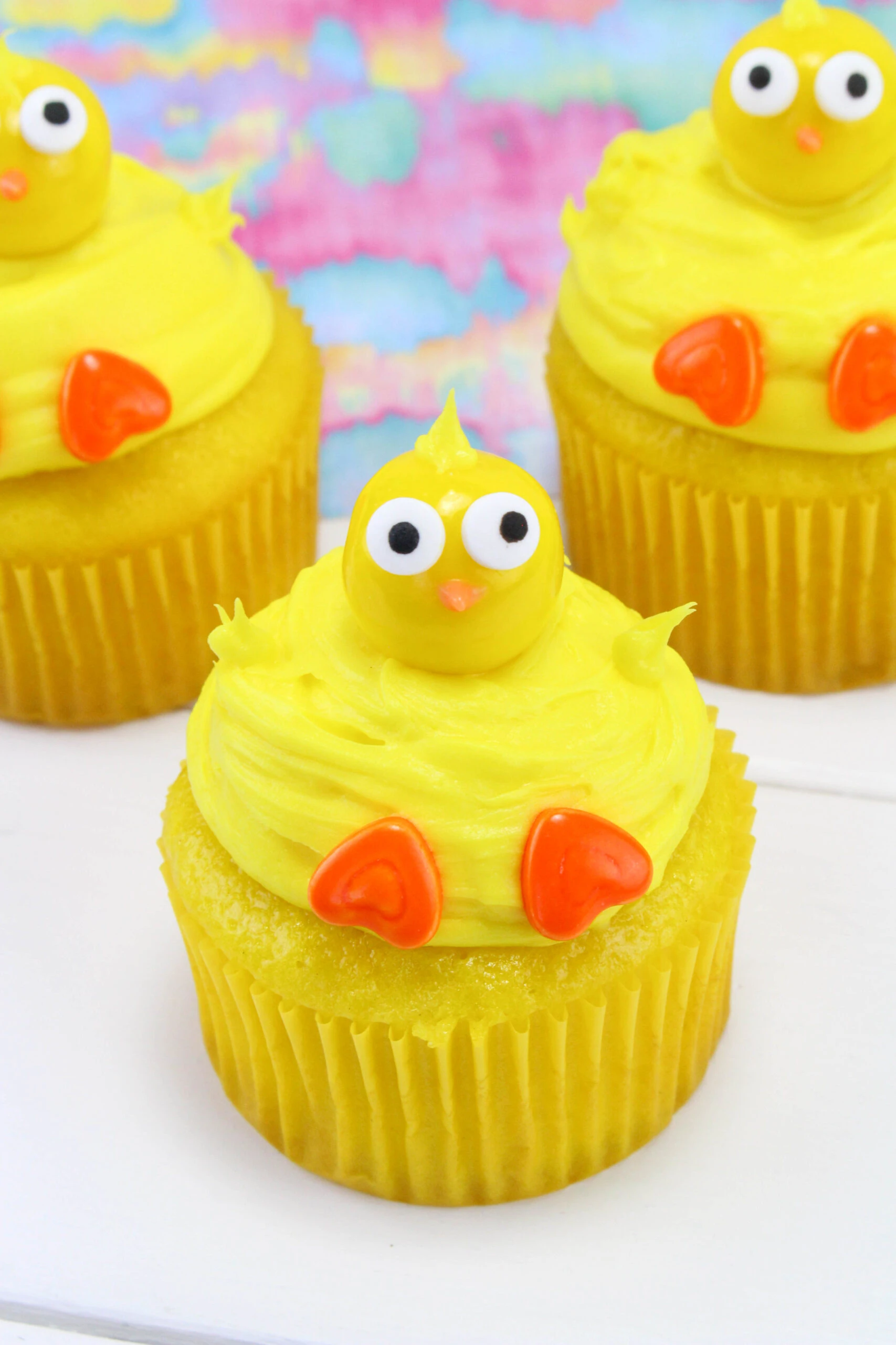 You'll love how easy it is to make these delicious Chick Cupcakes. Get started with a boxed cake mix for the cupcakes. Once baked and cooled, top the cupcakes with yellow frosting. Getting creative with candy pieces will help you form the chick. Use gumballs for the head and decorate the face with candy googly eyes and a nose. Add some candy feet and these chicks are ready for spring! via @Mooreorlesscook