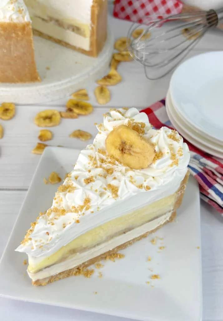A slice of banana cheesecake on a white plate.
