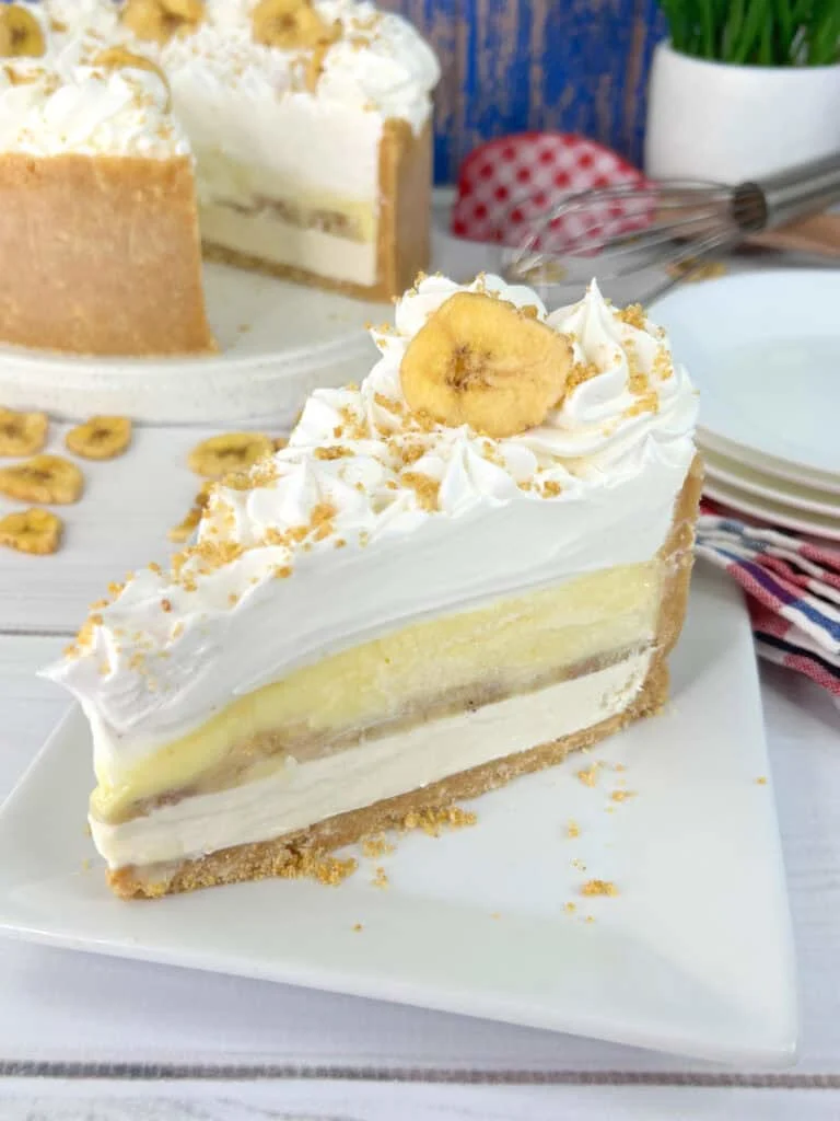 A slice of banana cheese cake on a white plate.