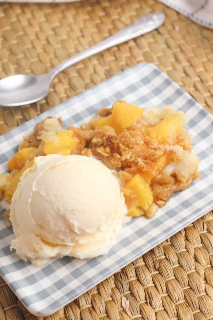 Peach crisp dump cake with vanilla ice cream.