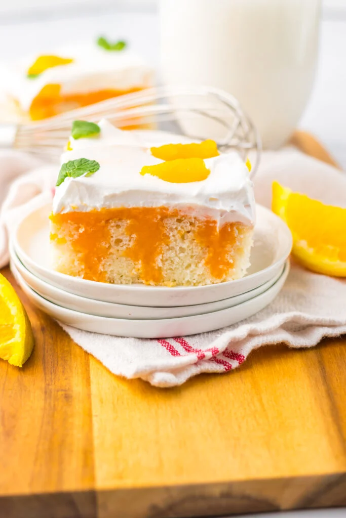 slice of poke cake on white plate
