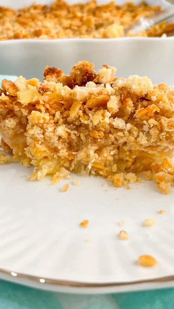 A slice of pineapple casserole on a white plate.
