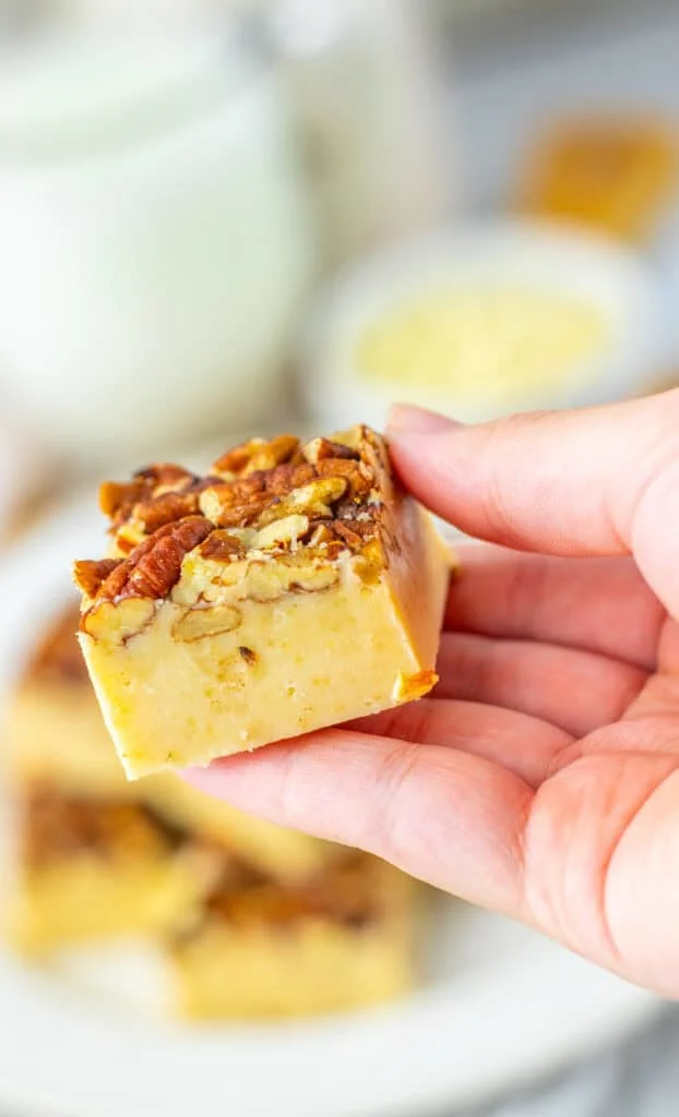Pecan Fudge square on hand, creamy caramel and crunchy pecan topping.