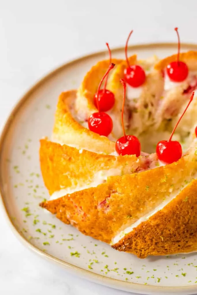 Golden cake with cherries and creamy filling, perfect for dessert or a special occasion.