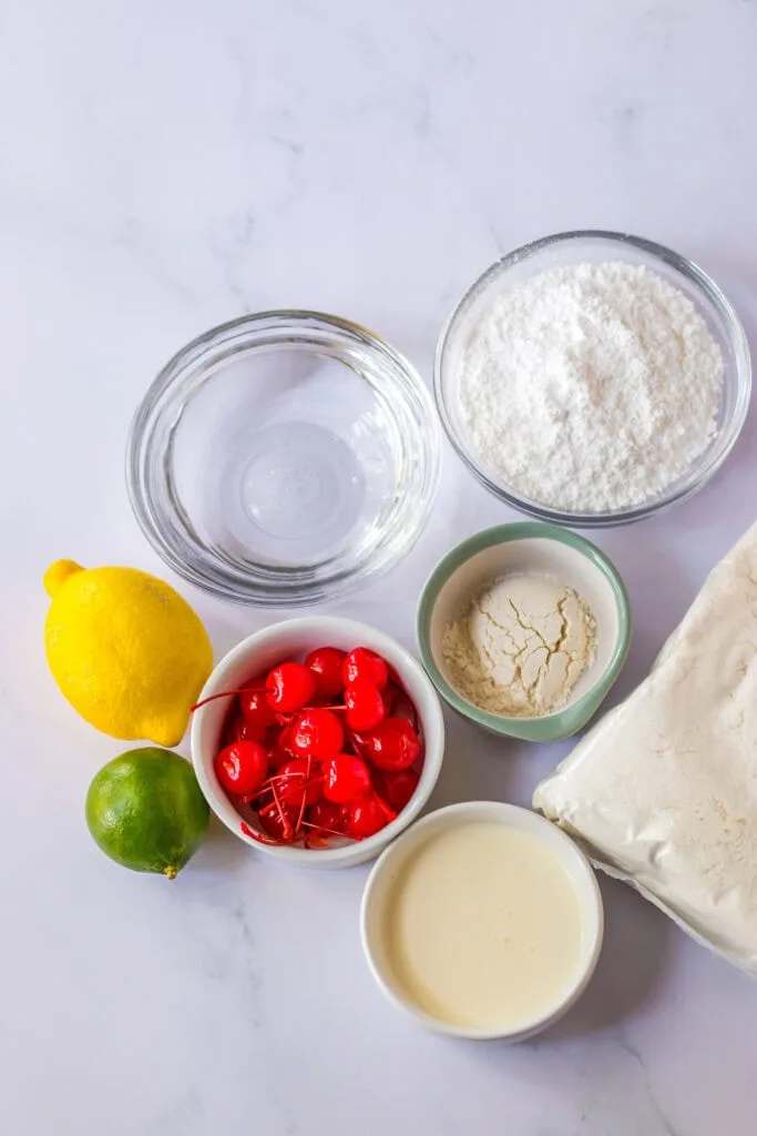 Baking ingredients including cake mix, eggs, lemon, lime, cherries, and dairy for dessert recipes.