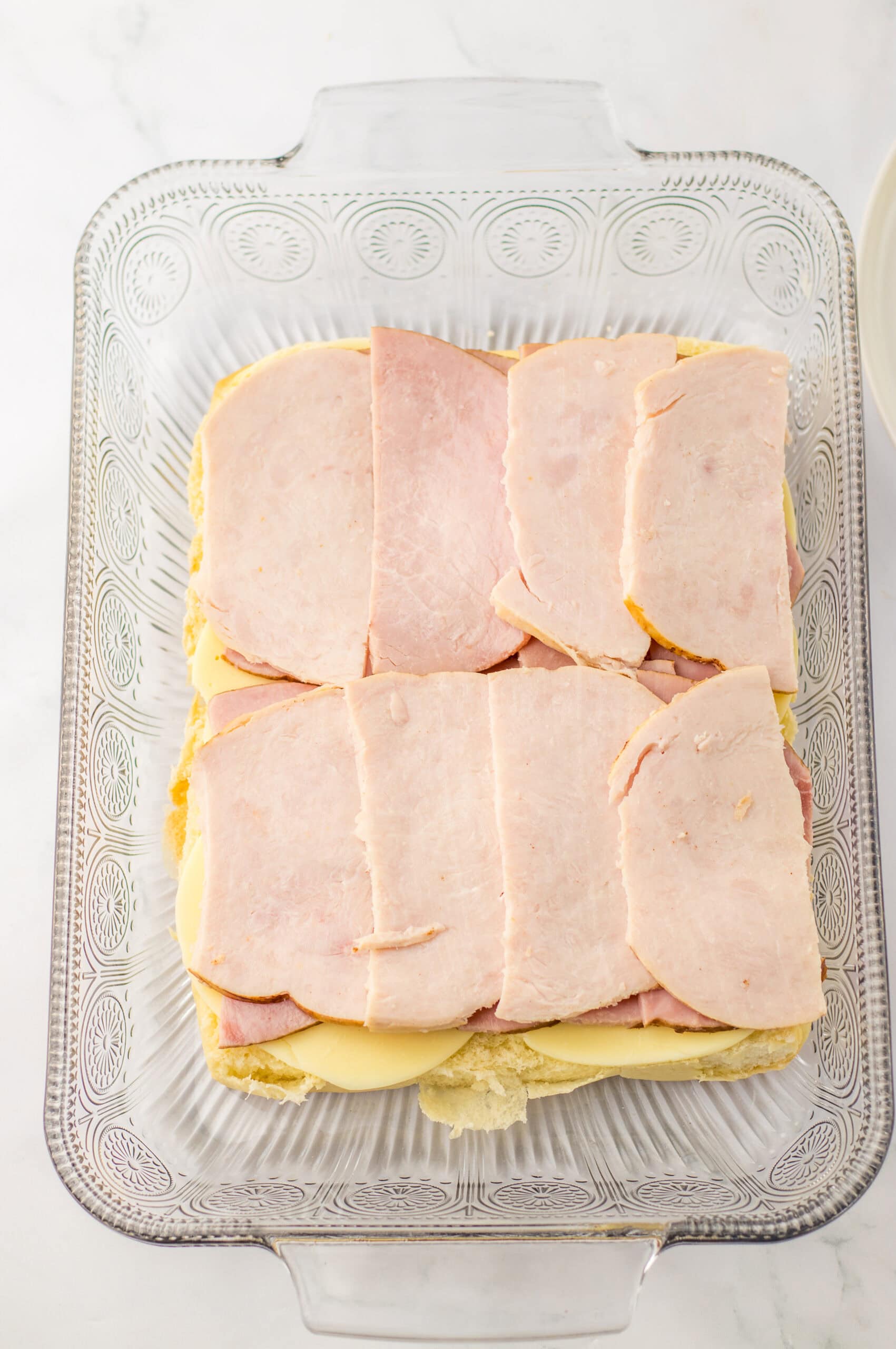 Sliced ham on a casserole dish for ham and cheese sandwiches or casserole recipes.