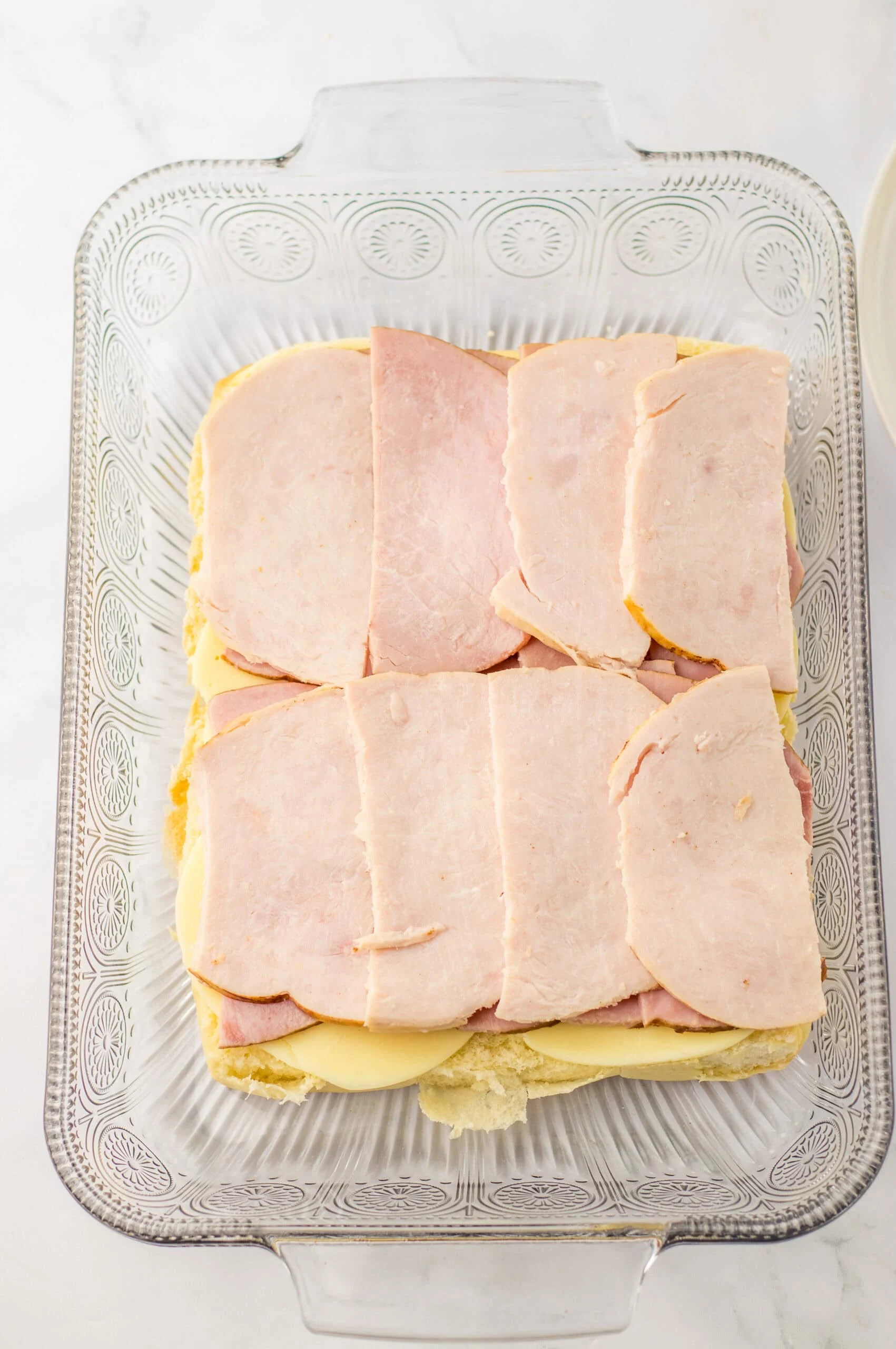 Sliced ham on a casserole dish for ham and cheese sandwiches or casserole recipes.