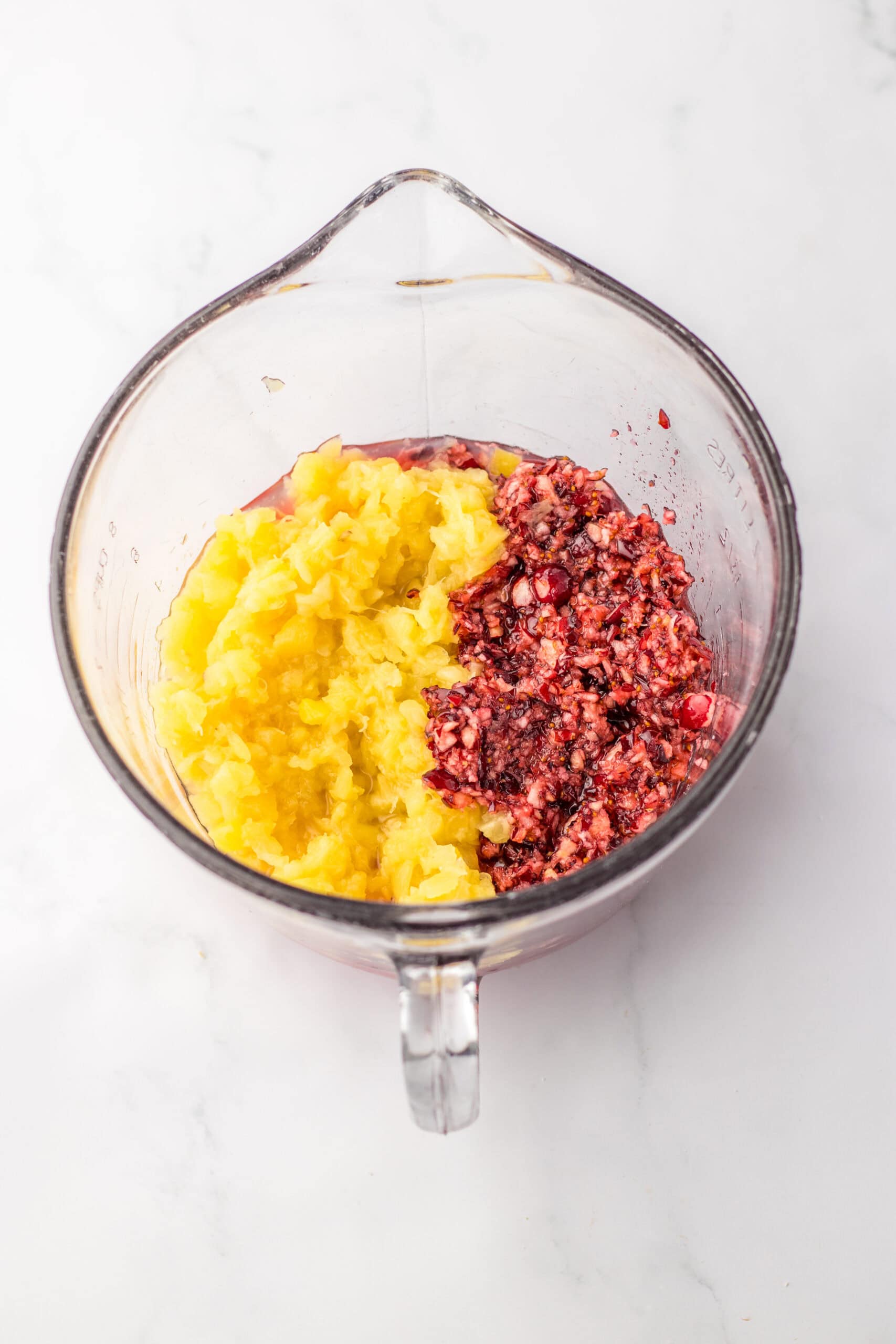 mixing pineapple and cranberries