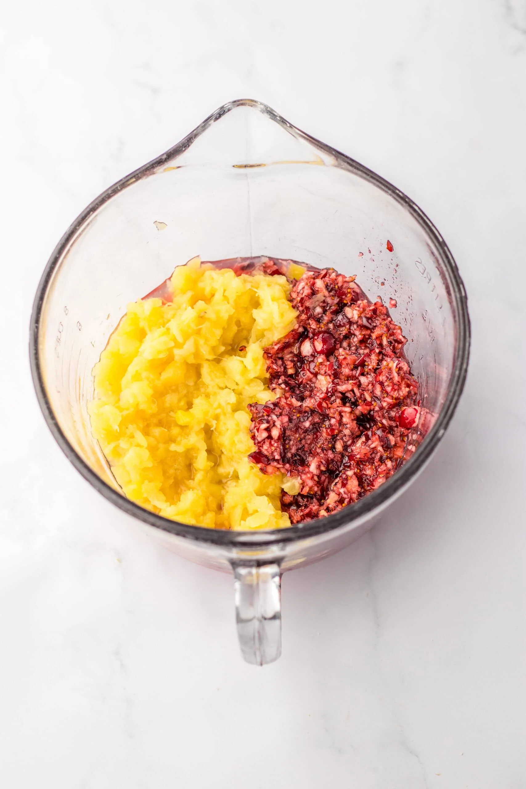 mixing pineapple and cranberries