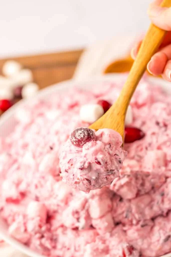 wooden spoon in cranberry fluff salad