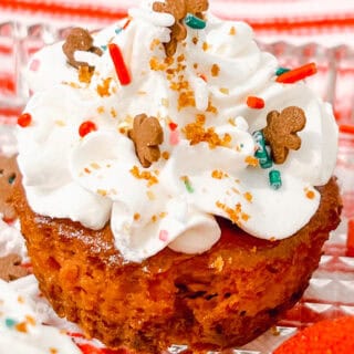 Gingerbread Cheesecake Bites cupcake with whipped cream, gingerbread men, sprinkles for holiday dessert.