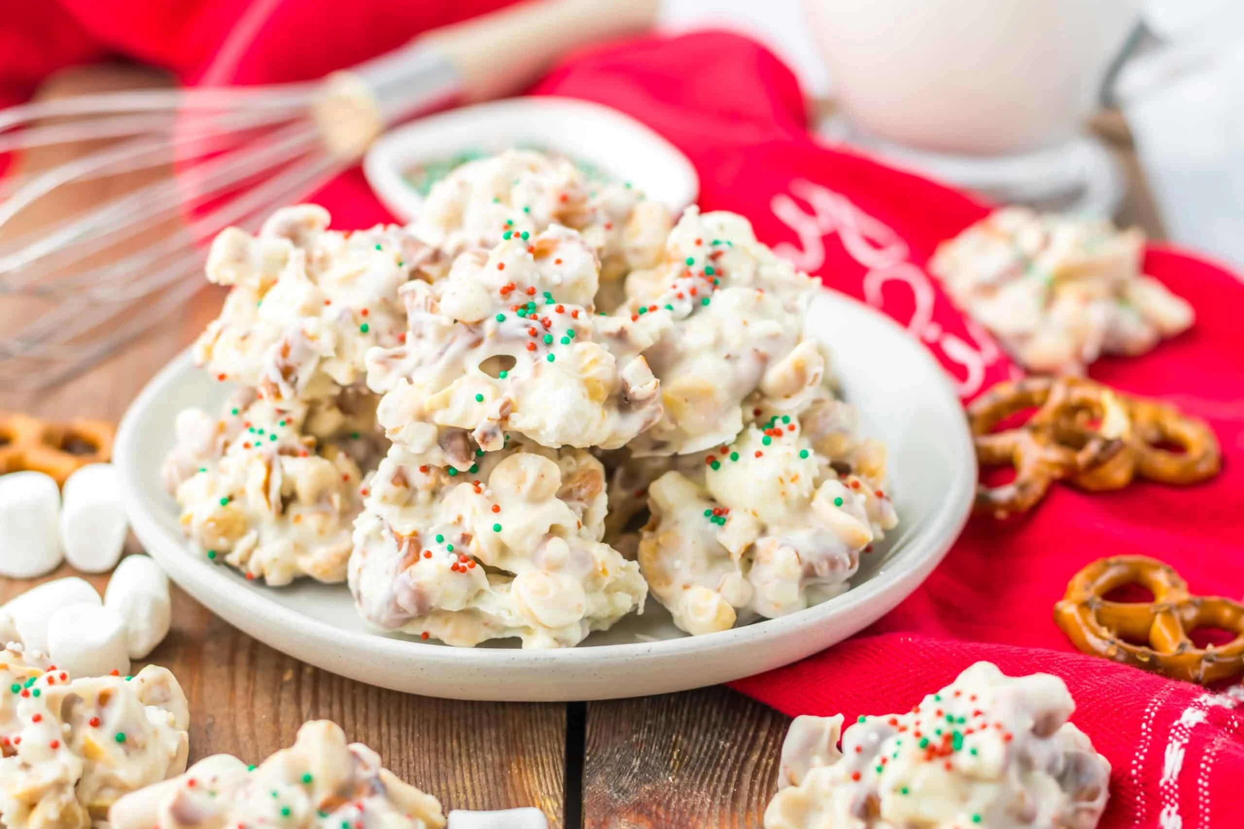 Creamy Christmas popcorn with colorful sprinkles, marshmallows, and holiday treats.
