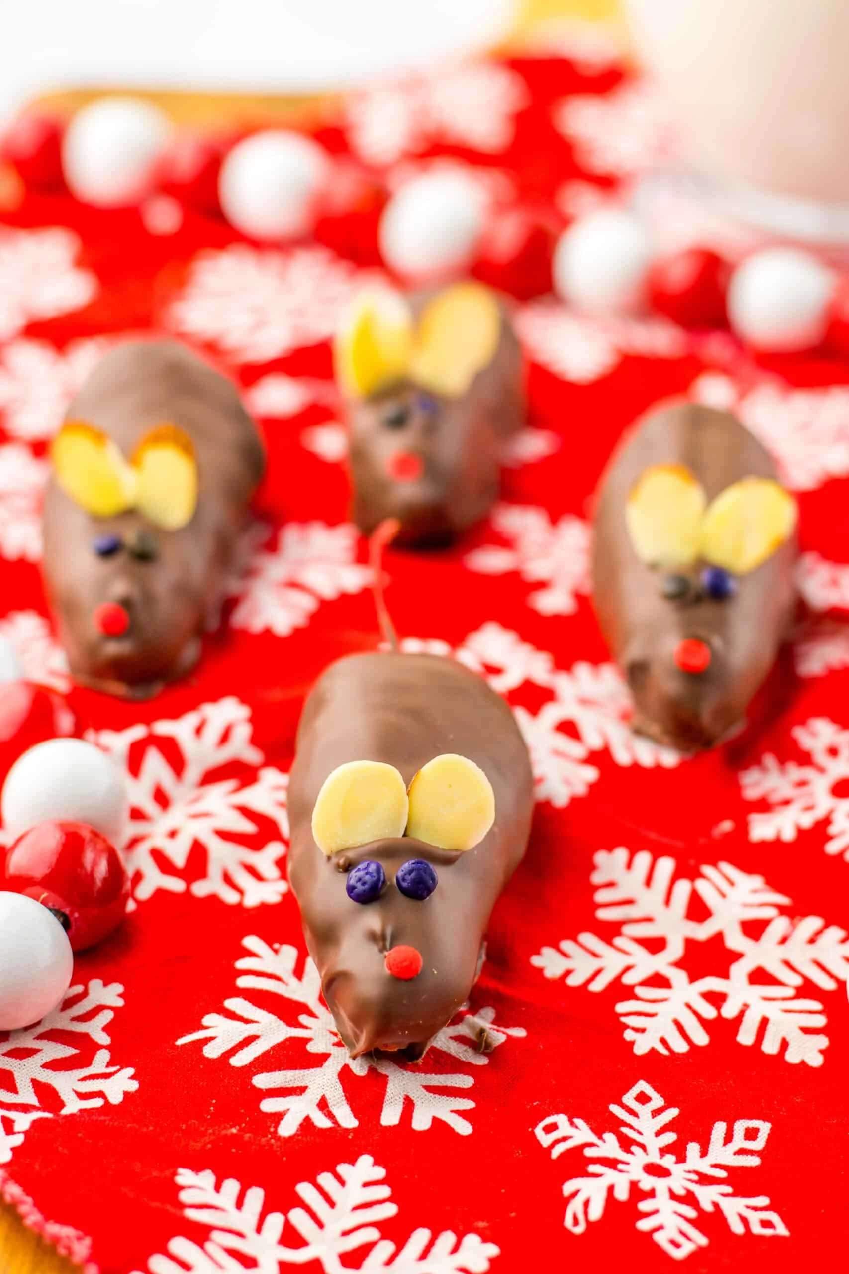 Miniature chocolate coconut mice for Christmas treats, decorated with candy eyes and ears. Perfect holiday dessert idea from Moore or Less Cooking.