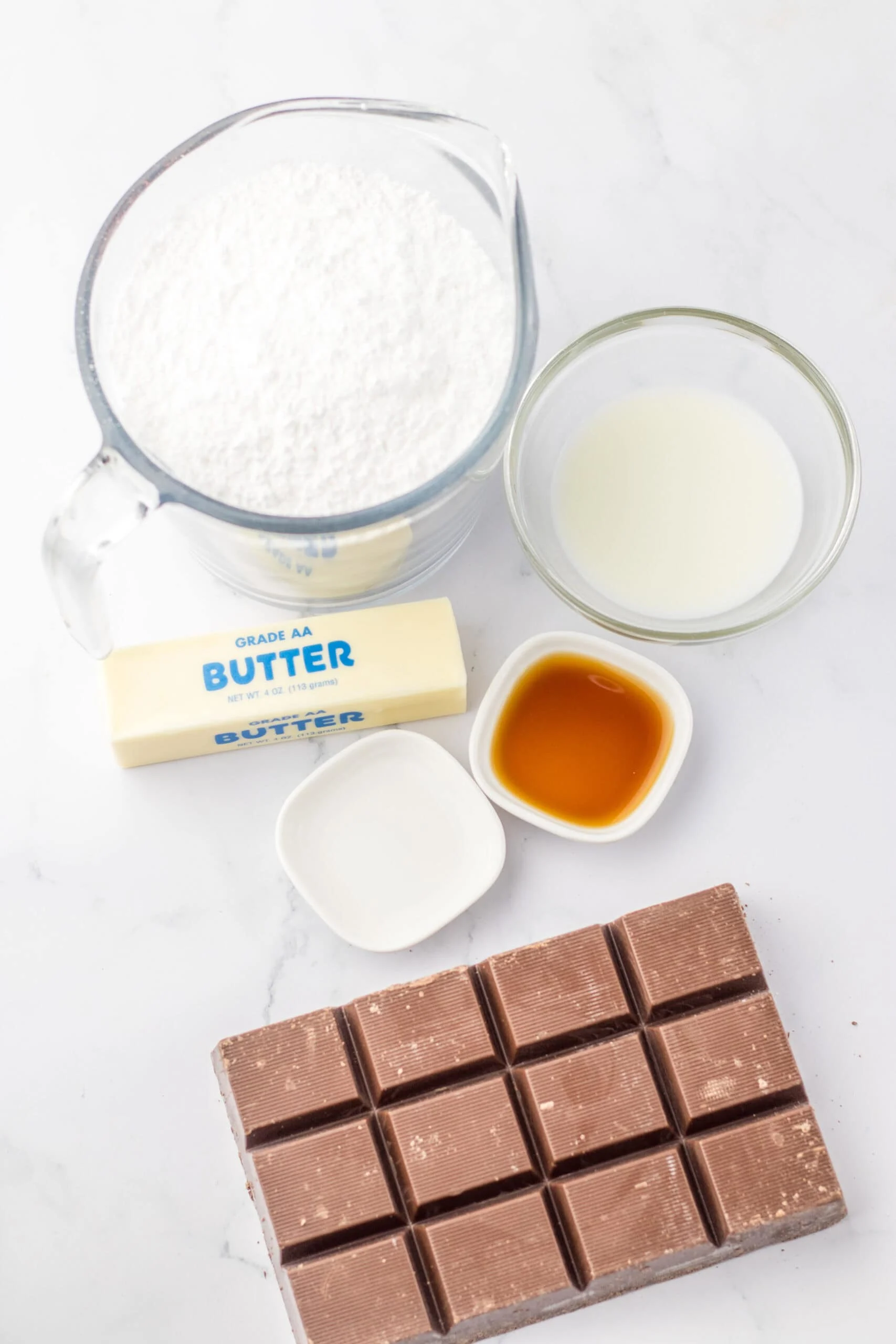 Alt text: Assorted baking ingredients including chocolate, butter, milk, flour, and vanilla extract to make truffles