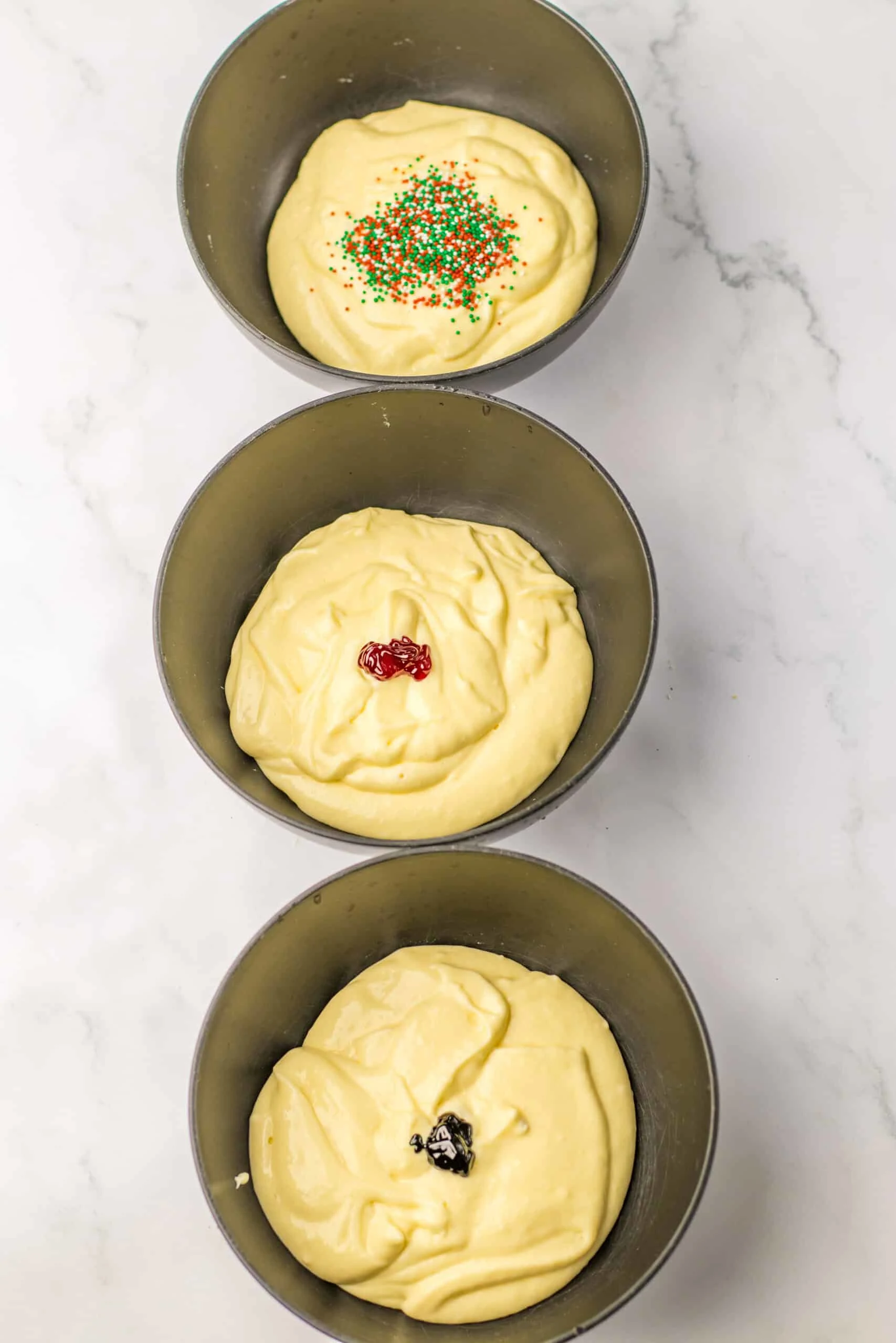 three bowls cheesecake batter