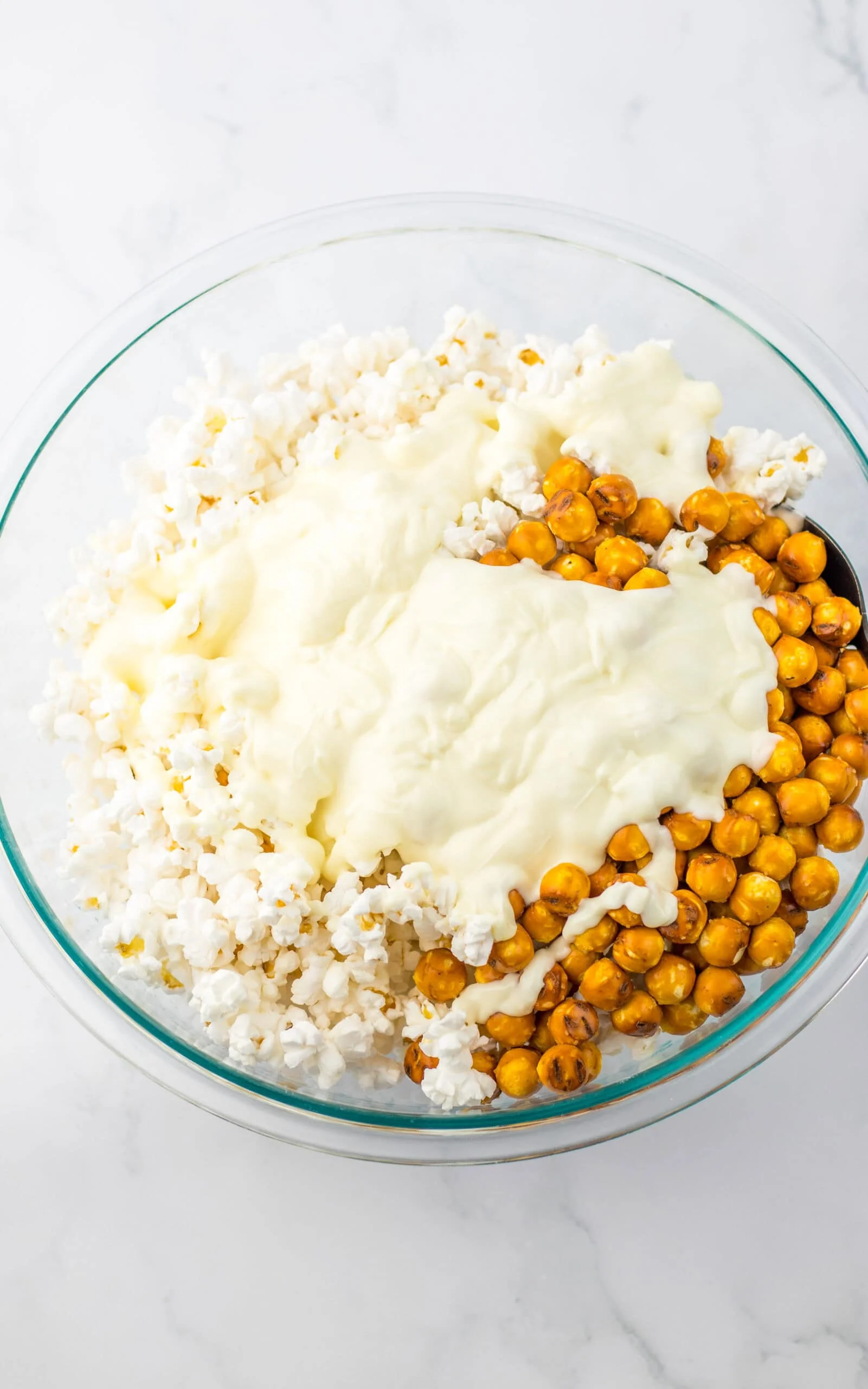 por melted chocolate over popcorn