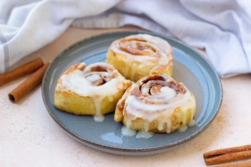 three cinnamon rolls on plate