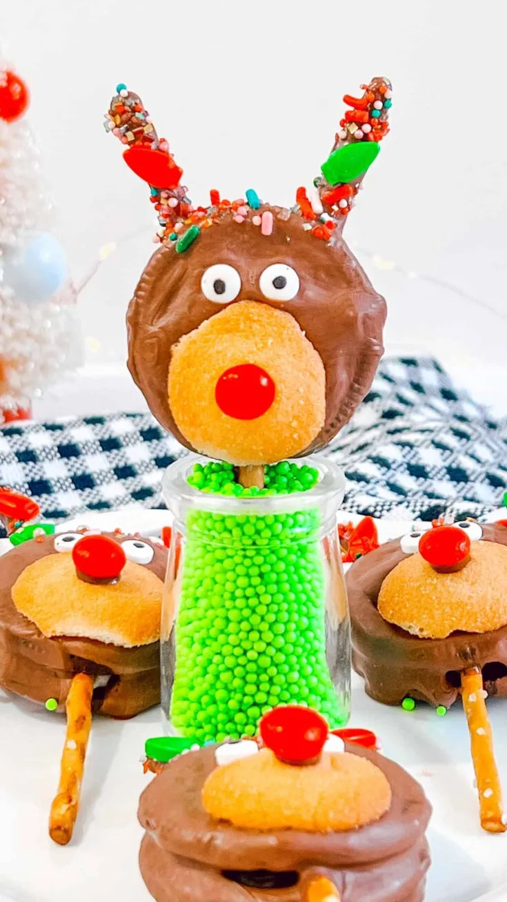 Reindeer Oreo Pops in glass filled with green candies