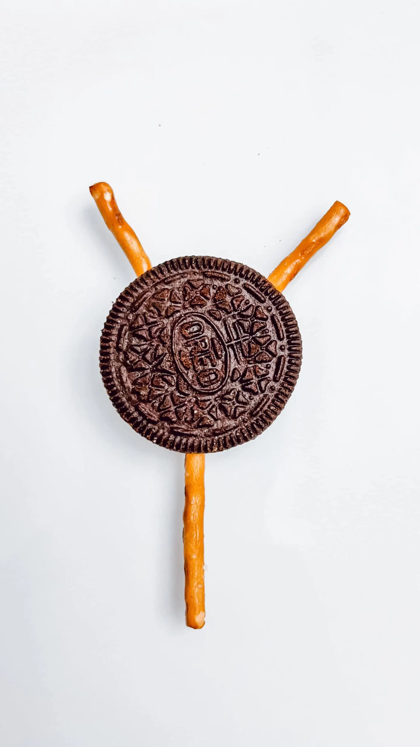 Making the reindeer head with oreo and pretzels