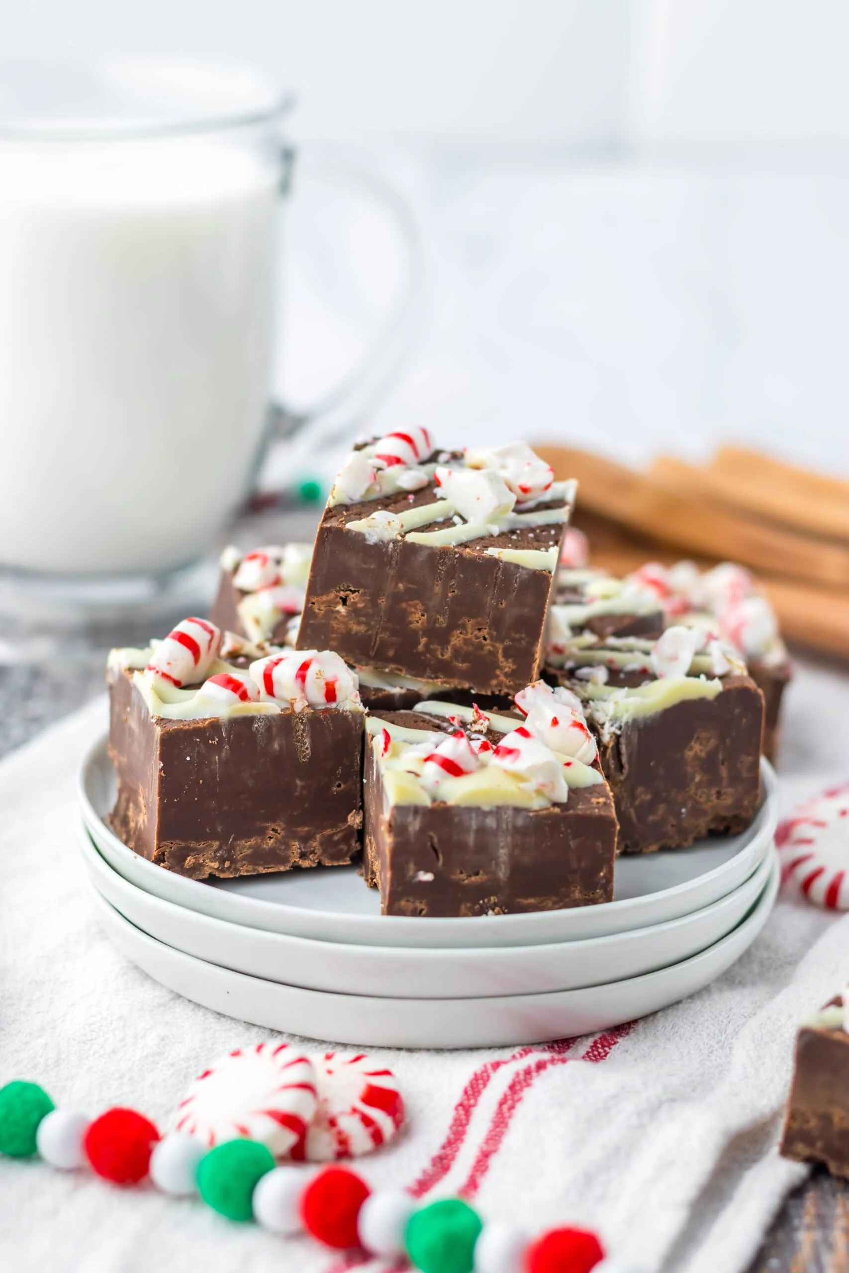 on white plates Slow Cooker Peppermint Bark Fudge cut up in chunks