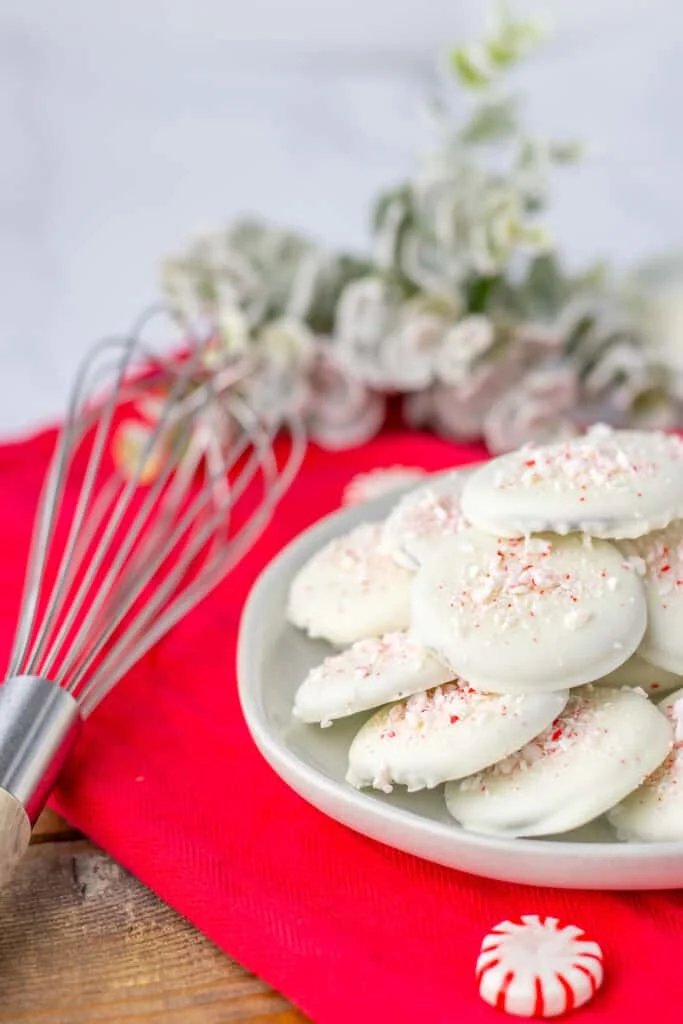 thin mints on platter with whisk and decorations, red table cloth
