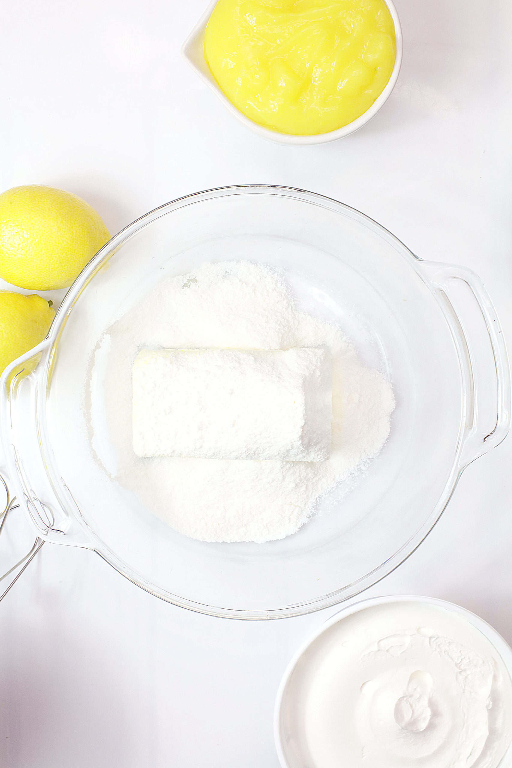 Ingredients for Limoncello Cream Cheese Pie with lemons and cream cheese.