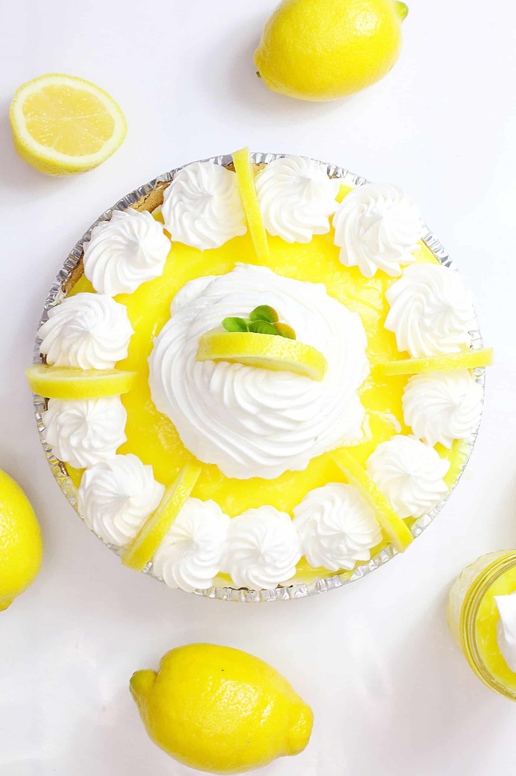 Delicious Limoncello Cream Cheese Pie with lemon slices and whipped cream topping. Perfect for summe.
