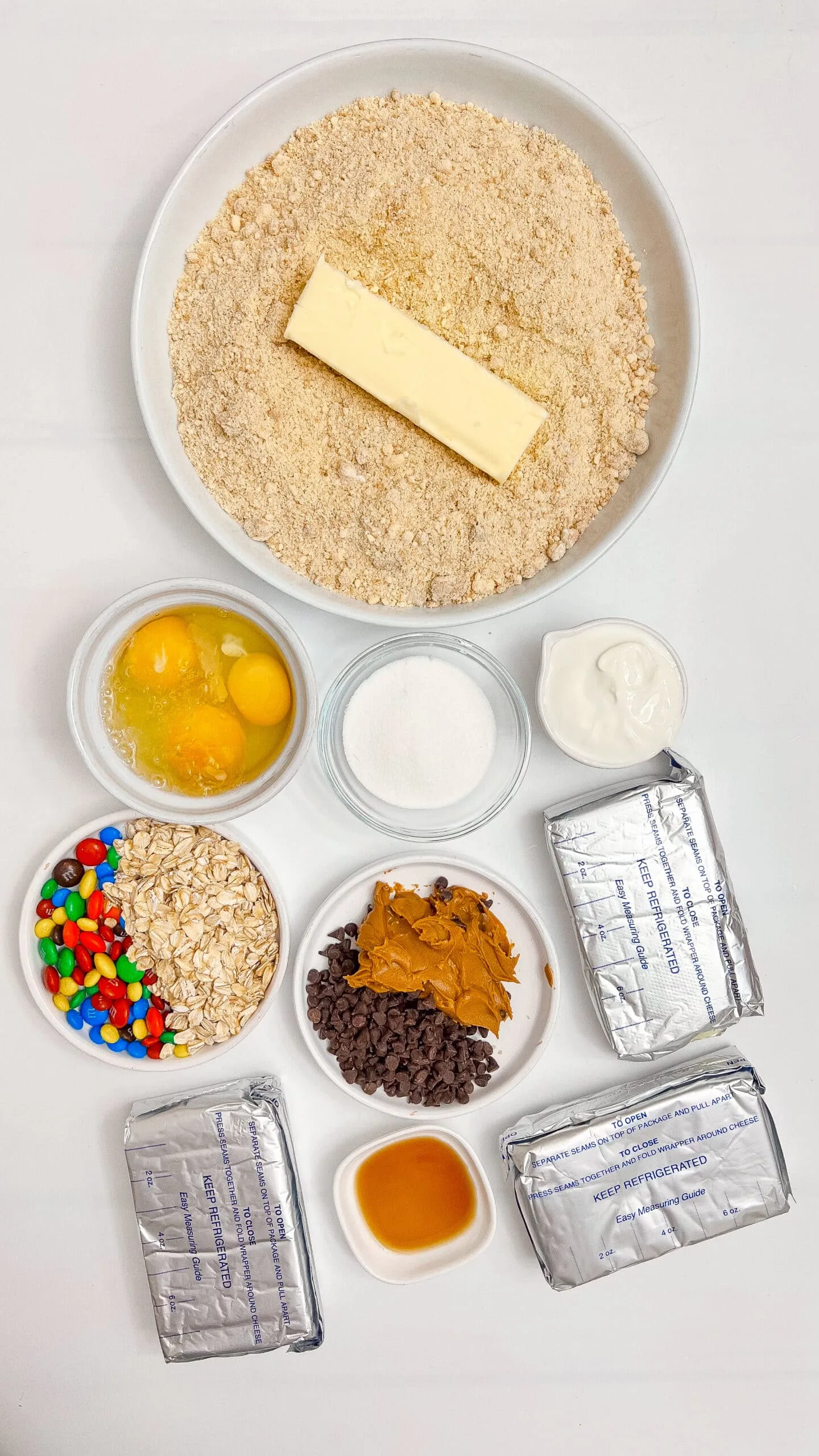 Cream cheese, chocolate chips, peanut butter, and cookie ingredients for cheeseburger stuffed cookies.