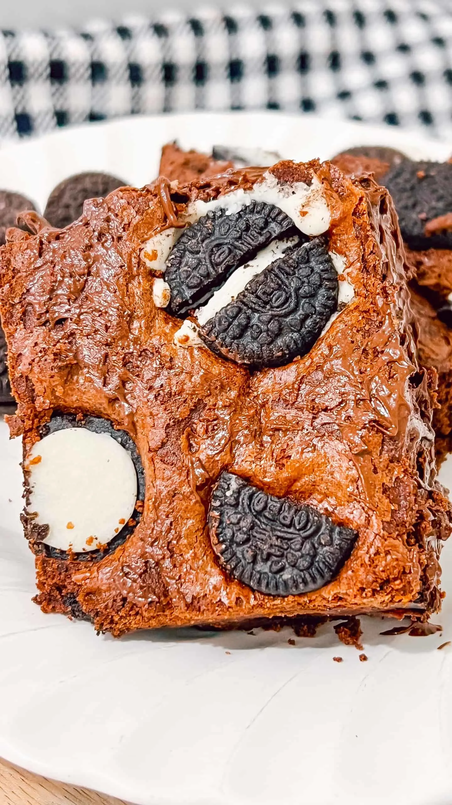 Delicious homemade chocolate brownie topped with Oreo cookies, perfect for dessert lovers.