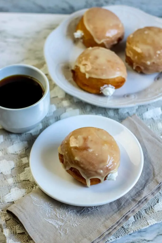 yeast-risen donut bakery-style vanilla pastry cream on white plates coffee cup
