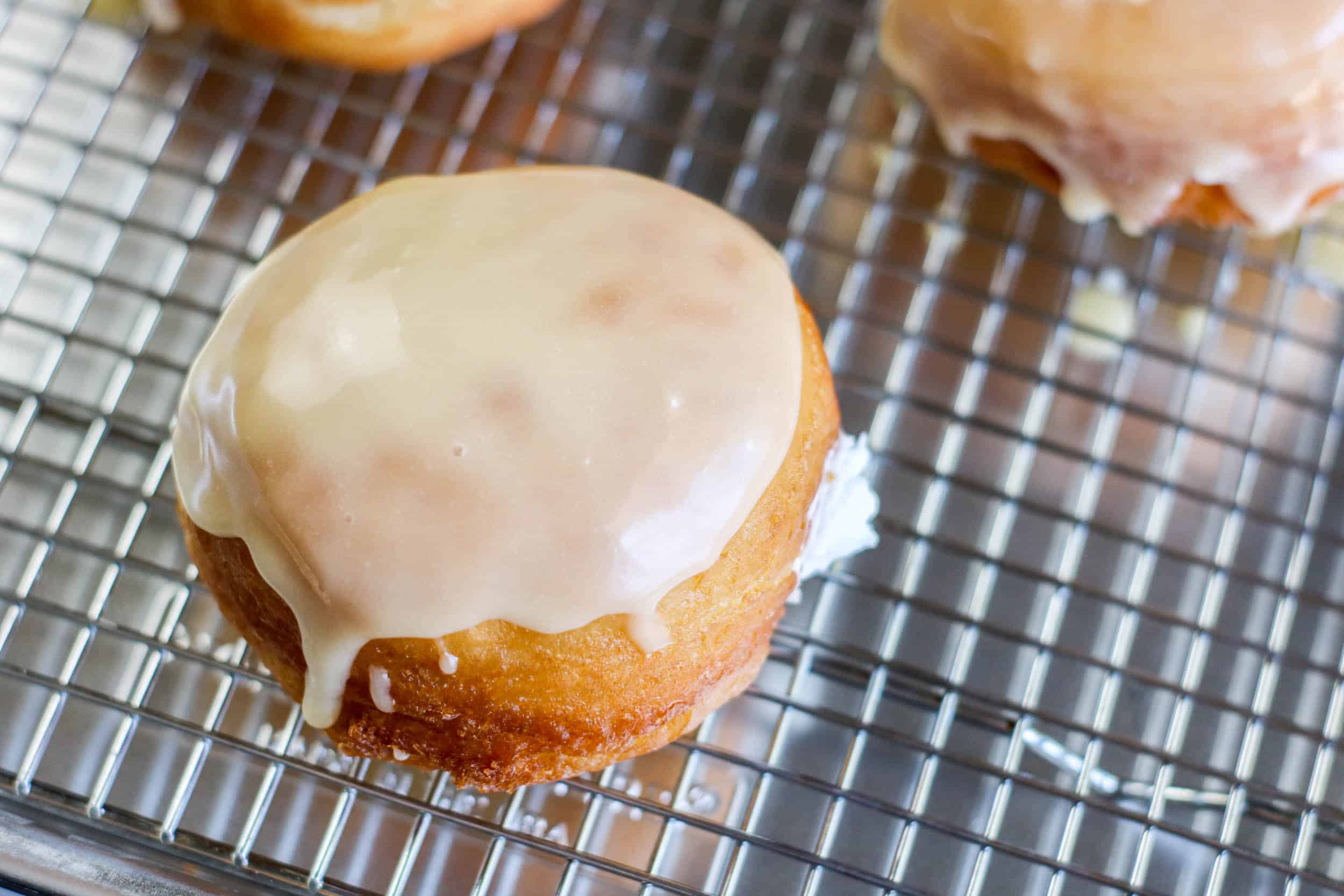 Filled doughnut with smooth glaze on top, perfect for sweet breakfast or dessert.
