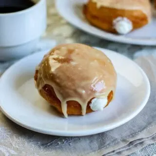 cream filled donuts with a cup of coffee