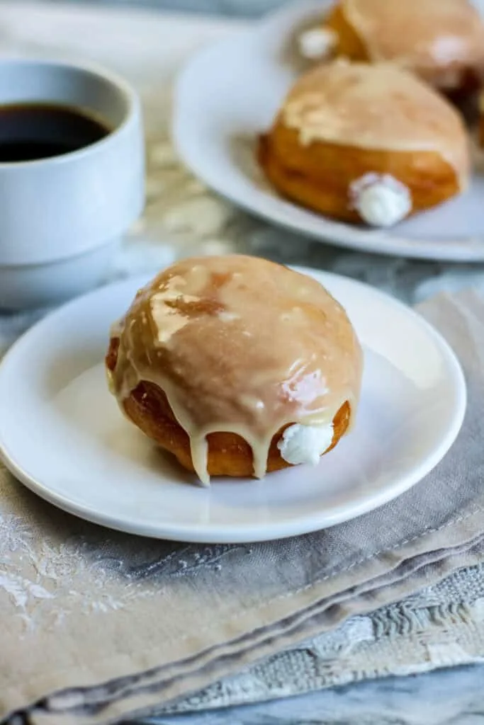 cream filled donuts with a cup of coffee