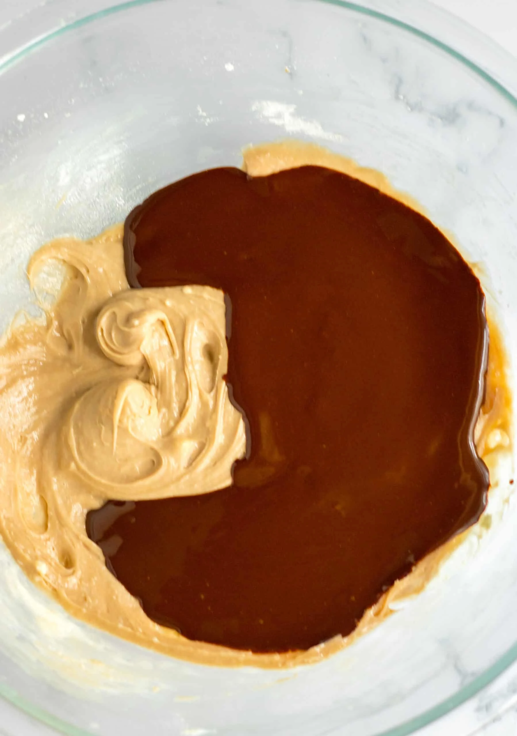French Silk Brownies chocolate and butter mixture in a glass bowl.