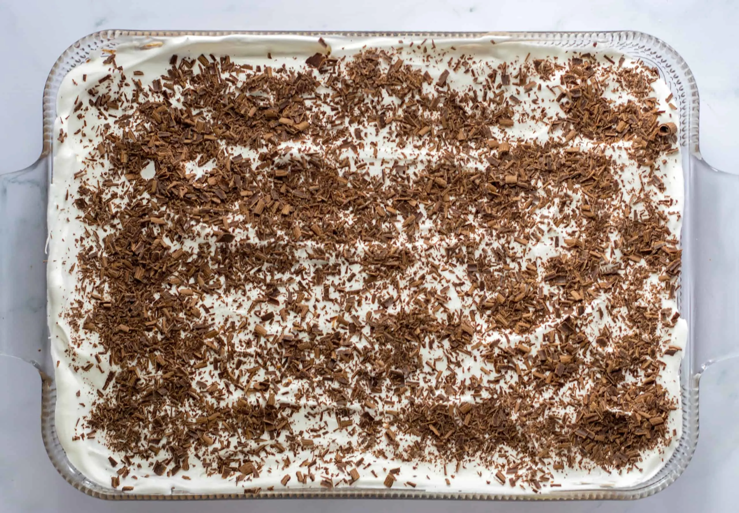 French Silk Brownies topped with chocolate shavings in a baking dish.