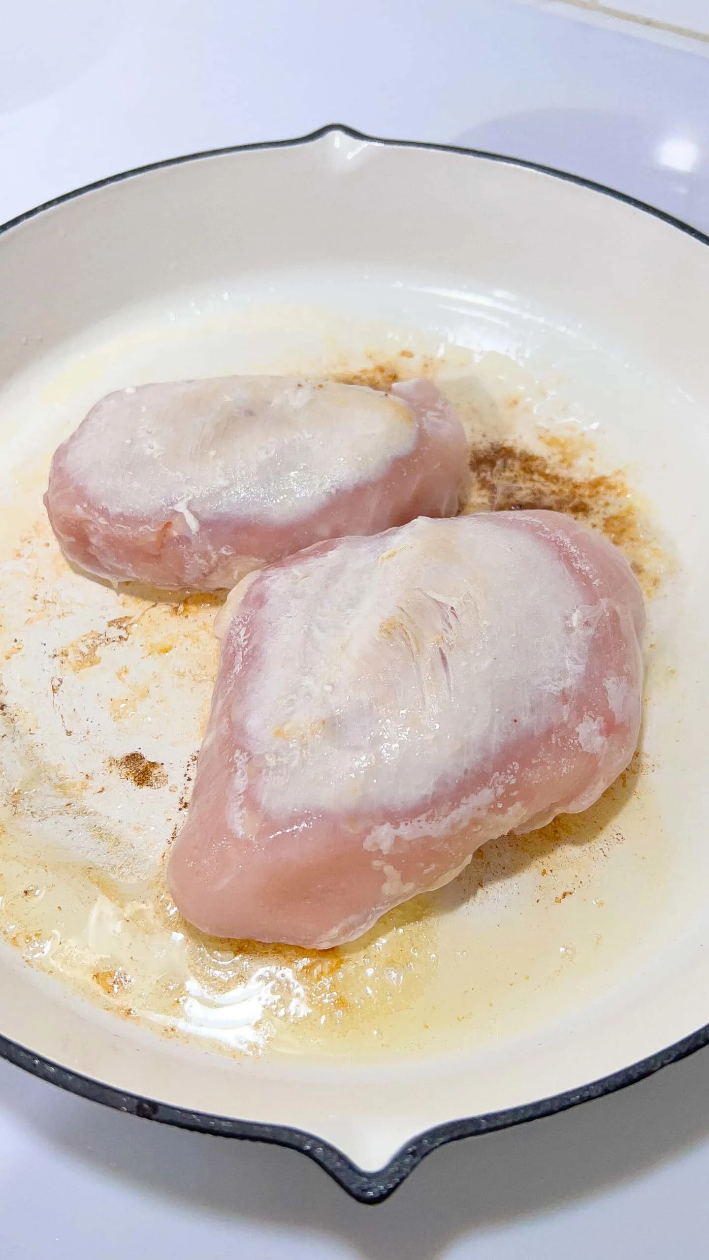 Angel Chicken breasts in creamy garlic sauce in a skillet.