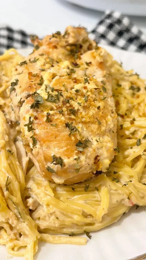 Creamy garlic sauce crockpot chicken over angel hair pasta