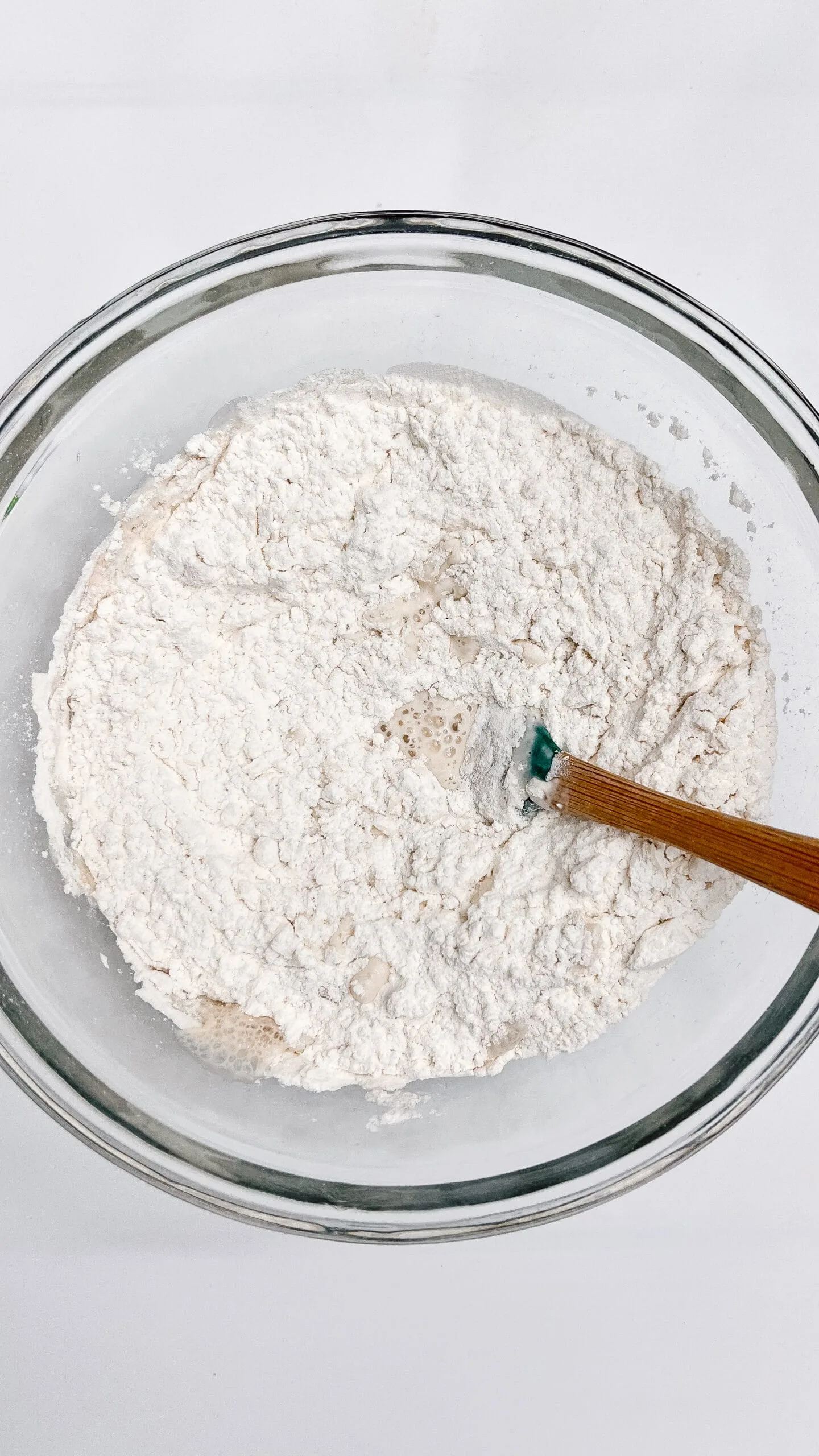 Close-up of flour mixture in glass bowl for Easter sourdough swirl bread.