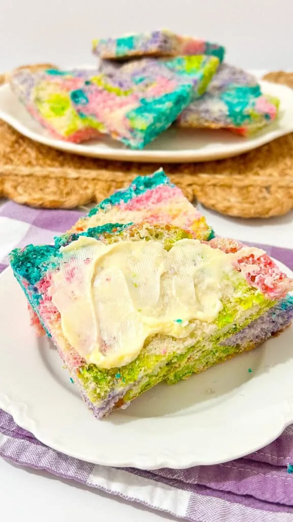 bread slathered with butter, plate of bread